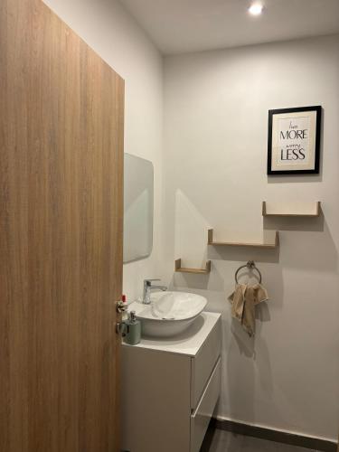 a bathroom with a sink and a mirror at Real Homes 2 bedroom Nova Apartments in Accra