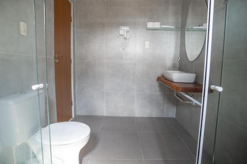 a bathroom with a shower and a toilet and a sink at Casa do Ney in Fernando de Noronha