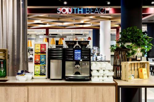 a store with a counter with a coffee maker on it at NH Noordwijk Conference Centre Leeuwenhorst in Noordwijkerhout