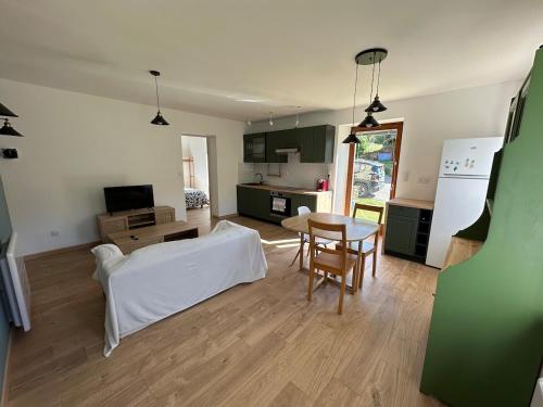 a kitchen and living room with a table and a couch at Appartement 4 personnes in Orbey