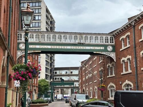 a bridge over a street in a city with buildings at Urban City Centre Apartment 1 Private Parking in Hull