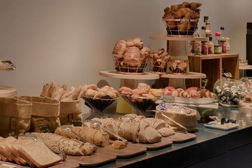 a table topped with lots of different types of bread at nhow Marseille in Marseille