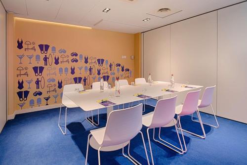 a conference room with a long table and chairs at nhow Marseille in Marseille