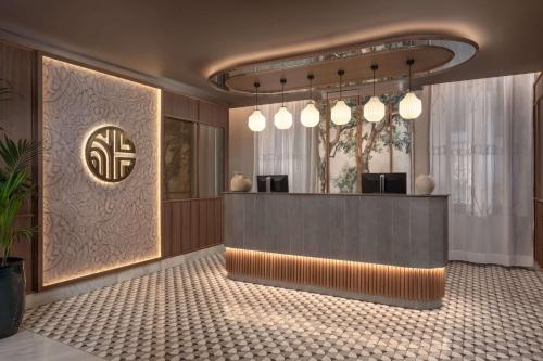 a lobby with a reception desk in a building at NH Collection Victoria in Granada
