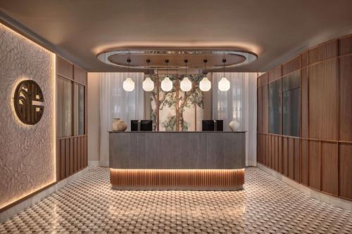 a lobby with a reception desk in a building at NH Collection Victoria in Granada