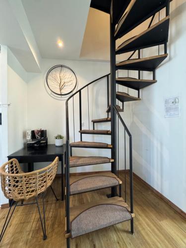a spiral staircase in a room with a desk at Maison cosy, climatisation et jardin in Tours