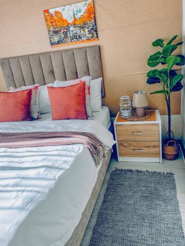 a bedroom with a bed and a nightstand with a plant at 2Bed in exquisite golf estate! in Roodepoort