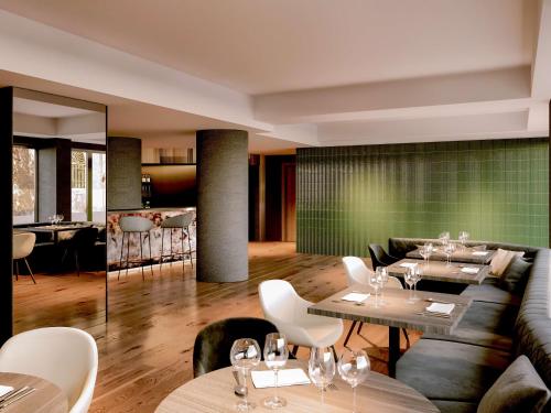 a restaurant with tables and chairs and a couch at NH Collection Roma Giustiniano in Rome