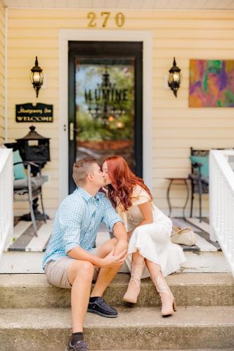 a bride and groom kissing on the steps of a house at Montgomery Inn BnB in Versailles
