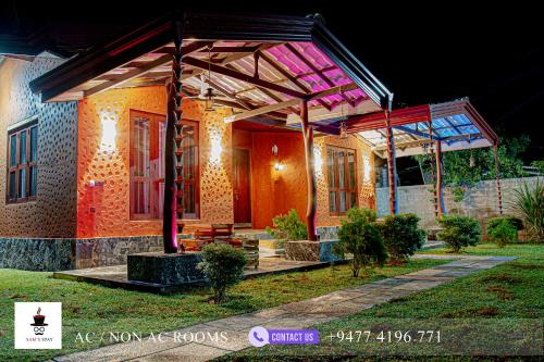 a house with a pavilion on the front of it at Sam's Stay Buduruwagala in Wellawaya