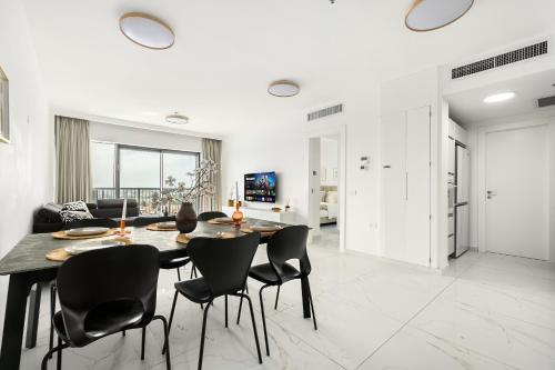 a dining room with a table and chairs at MR savyon view 2BR with balcony in Jerusalem