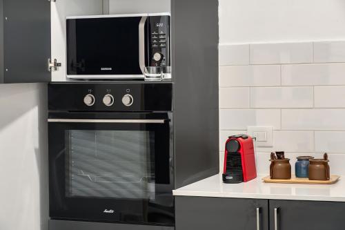 a microwave oven sitting on top of a stove in a kitchen at MR savyon view 2BR with balcony in Jerusalem