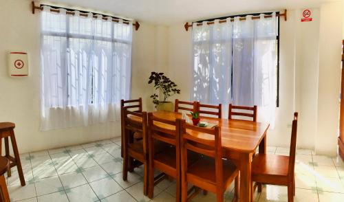 a dining room with a wooden table and chairs at Casa de Pablo in Puerto Ayora