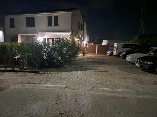 a parking lot in front of a house at night at Locanda Divinis in Cerea