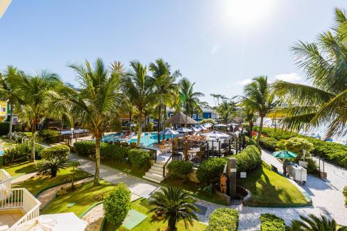 an aerial view of a resort with a pool and palm trees at Hotel Vila do Farol in Bombinhas