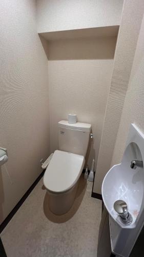 a bathroom with a toilet and a sink at Goddessガッデス in Yokosuka