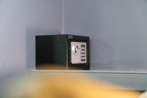a microwave sitting on a shelf in a room at MONS hostel in Buenos Aires