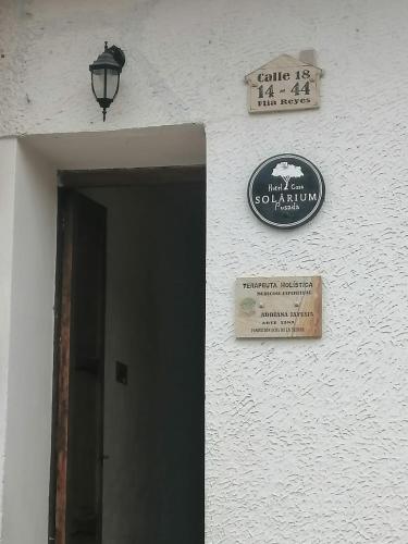 a sign on the side of a building with a doorway at Hotel Casa Solárium Posada in Socorro