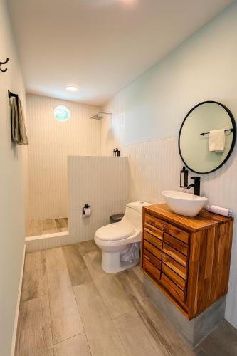 a bathroom with a toilet and a sink and a mirror at Fragata Island House in Isla Grande