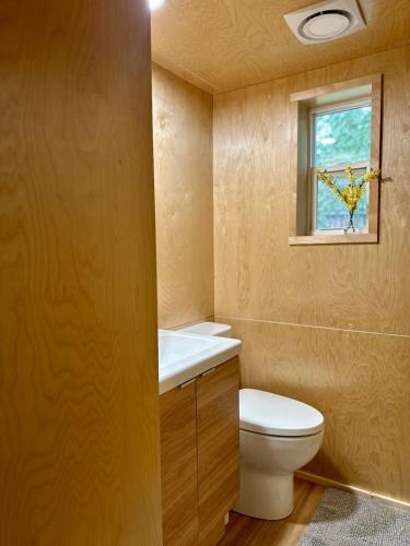 a bathroom with a toilet and a window at Riverside Retreat in Cowichan Bay