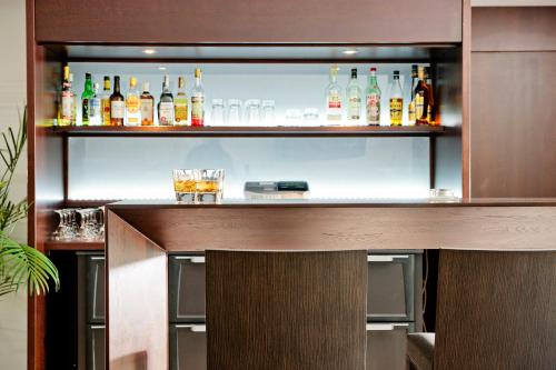 a bar with many bottles of alcohol in it at Acropolis Hill Hotel in Athens
