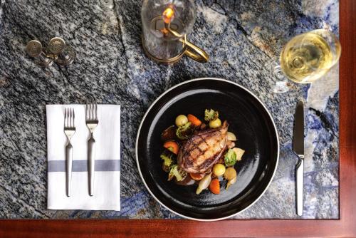 a plate of food with meat and vegetables on a table at The Westgate Hotel in San Diego