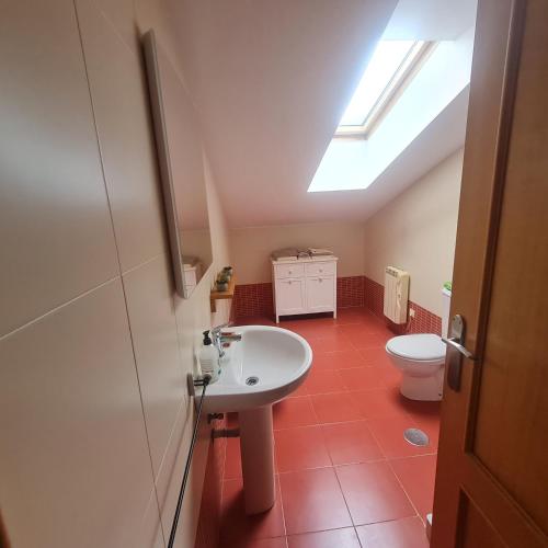 a bathroom with a sink and a toilet at Ático Felechosa loft in Felechosa