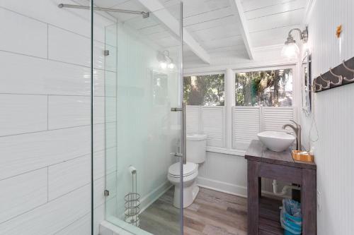 a bathroom with a toilet and a glass shower at 559 Magnolia Ave in Demere Park