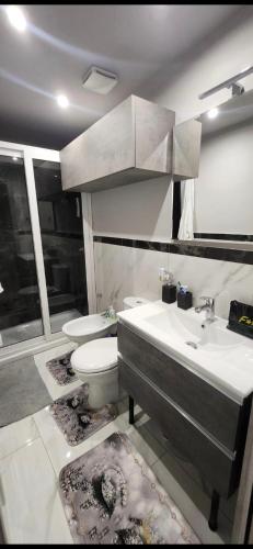 a bathroom with a sink and a toilet at Albicocche house Catania in Catania