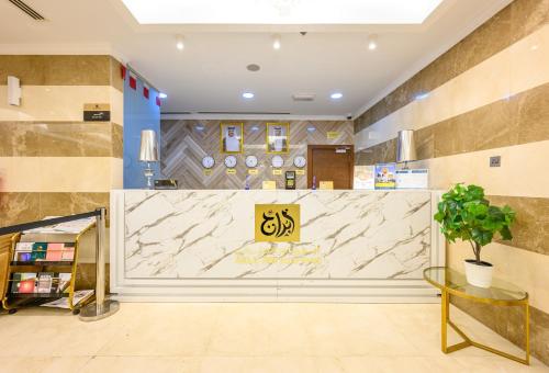 a lobby of a store with a large marble counter at Abraj INN Royal Hotel فندق أبراج إن الملكي in Doha