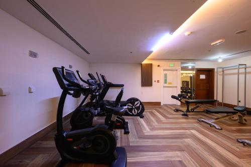 a gym with treadmills and exercise bikes in a room at Abraj INN Royal Hotel فندق أبراج إن الملكي in Doha