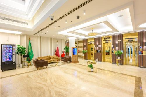 a lobby with couches and chairs in a building at Abraj INN Royal Hotel فندق أبراج إن الملكي in Doha
