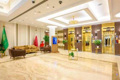 a lobby with couches and chairs in a building at Abraj INN Royal Hotel فندق أبراج إن الملكي in Doha