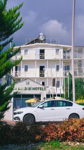 a white car parked in front of a hotel at MOY Beldibi Hotel in Antalya