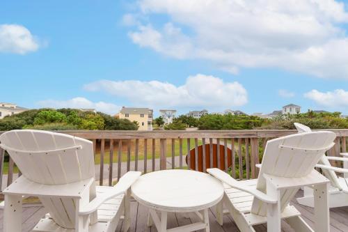 two white chairs and a table on a deck at 2064 - Just Ducky II in Poteskeet Village