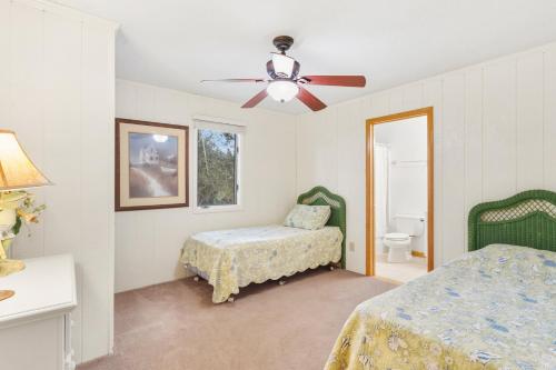 a bedroom with two beds and a ceiling fan at 2064 - Just Ducky II in Poteskeet Village