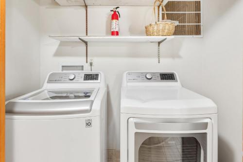 a small laundry room with a washer and dryer at 2064 - Just Ducky II in Poteskeet Village