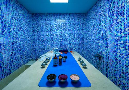 a blue room with a table with doughnuts on it at Abraj INN Royal Hotel فندق أبراج إن الملكي in Doha