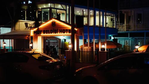 a restaurant sign in front of a building at night at MOY Beldibi Hotel in Antalya