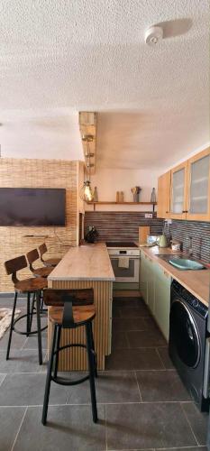 a kitchen with a table and chairs in it at Taff Cottage - Free parking, Fast Wifi, Comfy Stay in Cardiff