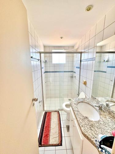 a bathroom with a shower and a sink and a toilet at Apartamento 2 quartos em Rio Quente in Rio Quente