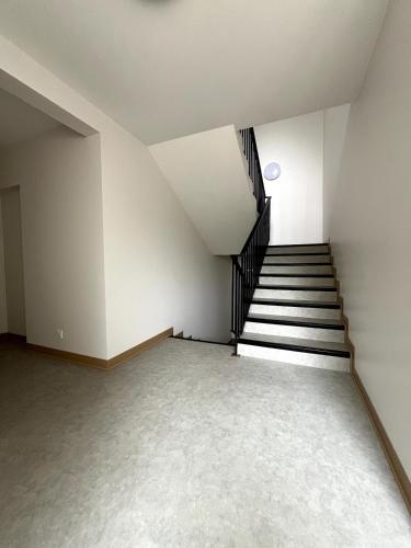 an empty room with stairs and a stair case at Bienvenue à L'Oustalet - Studio 3 in Cazaubon