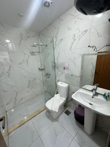 a bathroom with a toilet and a sink and a shower at &pyramids &Prince &view2 in Cairo