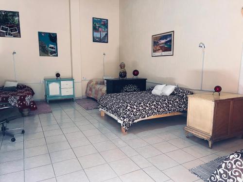 a bedroom with a bed and a desk and a table at Casa Abundia in La Calera