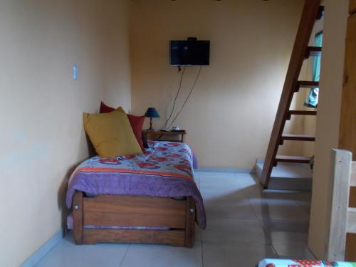 a bedroom with a bed in a room with a staircase at Rosa Ignea in Valle Hermoso