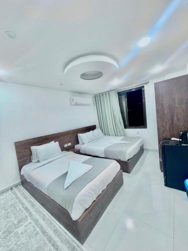 a hotel room with two beds and a television at &pyramids &Prince &view2 in Cairo