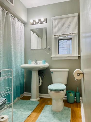 a bathroom with a toilet and a sink at Central Chic on Washington in Evansville