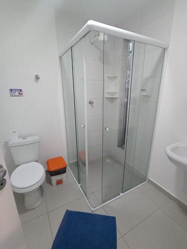 a bathroom with a shower with a toilet and a sink at WeStay Nova Cidade in São Paulo