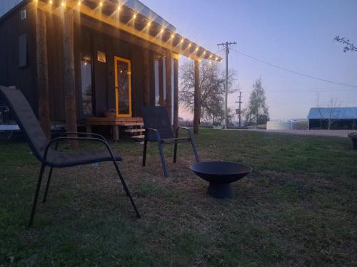 a tiny house with a bench and lights on it at The Orchard View by Tiny Away in Lidster