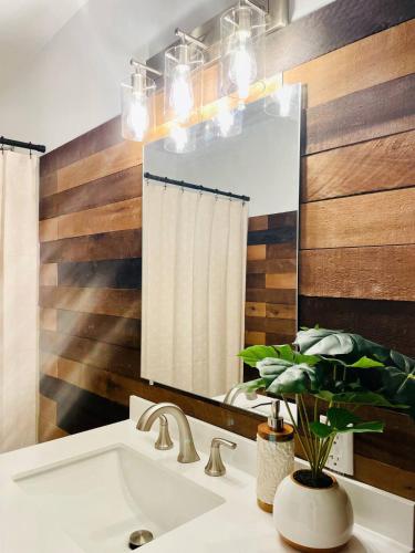 a bathroom with a sink and a mirror at Centrally Located EVV Apartments in Evansville